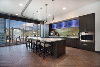 Community kitchen with island seating and pendant lights